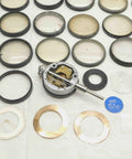 Solid Haul Of Dial Test Indicator Spare Parts And Heavy Duty Hardware For Precision Measuring Tools BR11576CZ5 assorted metal parts and rings for precision tools on a workbench