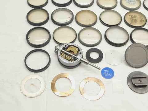 Solid Haul Of Dial Test Indicator Spare Parts And Heavy Duty Hardware For Precision Measuring Tools BR11576CZ5 assorted metal parts and rings for precision tools on a workbench