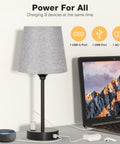 Set of Two Grey Bedside Lamps With USB C Port And AC Outlet 3 Way Dimmable Touch Control Nightstand Lamps shown charging devices