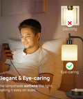 Man using phone with Dope Industrial Table Lamp Set Of 2 With Stepless Dimming USB Ports glass shade beside him on bed.
