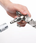 Close-up of hand holding 2-Way Air Hose Splitter Manifold with Quick Connect Fittings Two Universal Type Couplers and Industrial Type Plug