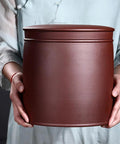 Heavy Hitter Ceramic Rice Jar Round With No Sweat Seal, Retro Large Capacity Airtight Grain Bucket held in hands.