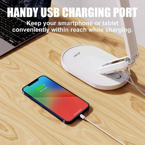 Eye Care Desk Lamp With USB Charging Port Dimmable 5 Color Modes And 72 LED Full Spectrum Touch Control And Memory Function No Flicker Office Table Light For Reading And Studying shown with charging smartphone on a wooden desk