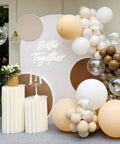 Elegant "Better Together" neon sign on decorated wall with balloons and candles for event decor