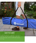 Person carrying blue bag for 7x7 Foot Golf Practice Net For Indoor Garage Or Outdoor Backyard Driving Heavy Duty Mesh Netting