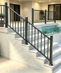 Heavy Duty Black Deck Railing Kit With Reinforced Aluminum Posts And Code Compliant Handrails on marble stairs with plants.