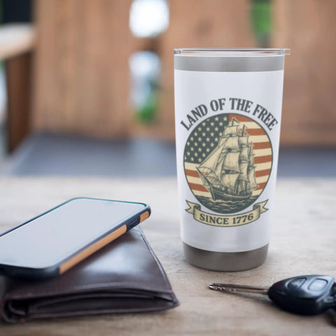 Patriotic Stainless Steel Insulated Tumbler With Sailboat American Flag Design Celebrating 1776 And The 4th Of July Red White And Blue Travel Mug For Independence Day on a wooden table