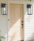 Dusk To Dawn Sensor Outdoor Wall Lantern With Black Finish Modern Wall Sconce For Exterior Wall Lights Weatherproof Outdoor Lighting Easy Mount Wall Mount Fixture mounted beside a wooden door