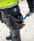 Person wearing Electrician's Padded Tool Belt And Pouch Combo, 11-Pocket 4-Piece Set With 8-Pocket Pouch on a work site.