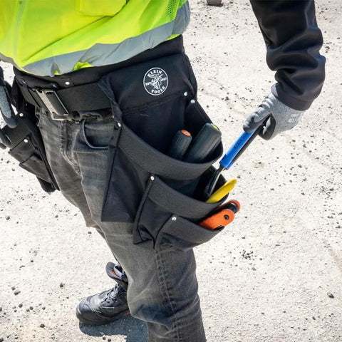 Person wearing Electrician's Padded Tool Belt And Pouch Combo, 11-Pocket 4-Piece Set With 8-Pocket Pouch on a work site.