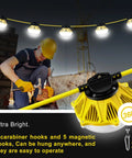Rugged 50 Ft LED Construction String Lights With 5 Sockets 100W illuminating a job site, featuring aluminum housing and carabiner hooks