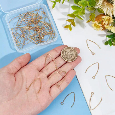 Golden V Shape Stainless Steel Earring Hooks, 50 Pcs Metal Ear Wires with Horizontal Loop shown in hand for scale.