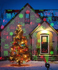 Holiday-decorated house with colorful projector lights and Christmas tree with Star String Lights 43 Ft 100 LED Warm White Fairy Lights With Extendable Waterproof Design 8 Modes For Indoor Outdoor Cozy Decor Perfect For Home Party Wedding Garden Christmas Party Ready.
