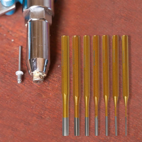 Solid Minhe 7 Piece Punch Set Includes Roll Pin And Chisel Tools Plus Marking Scribe For Watch Repair, Machinery Maintenance, DIY Jobs With Gold Alloy Steel Handle That Is Super Grip Friendly. Seven gold alloy steel punches with roll pin tool on wood surface