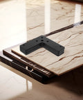 Black Stainless Steel L Shape Corner Brackets Pack Of Ten Heavy Duty Flat Angle Braces stacked on marble surface