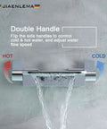 Black Wall Mount Waterfall Tub Faucet With High-Flow Tub Filler and Two-Handle Bathtub Wall Faucet in use on gray wall