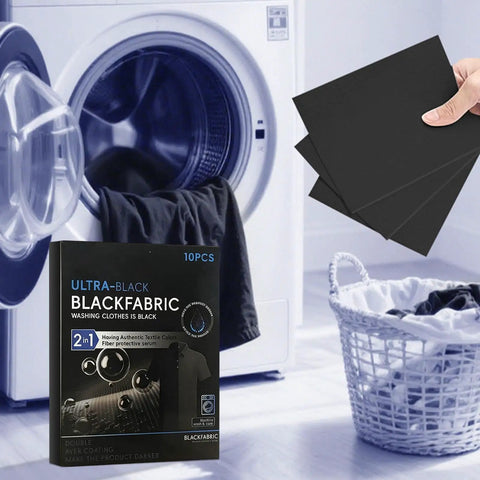 Black Fabric Dye Sheets 10 Pack That Restores Faded Clothes To Rich Black In Every Wash next to laundry machine and basket.