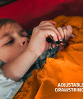 Child adjusting drawstring of All Season Camping Sleeping Bag For Adults And Kids Lightweight Packable Water Resistant Gear