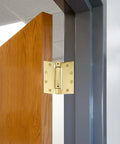 Heavy Duty 4.5 Inch Spring Hinge For Interior And Exterior Doors delivers automatic self closing performance on a wooden door.