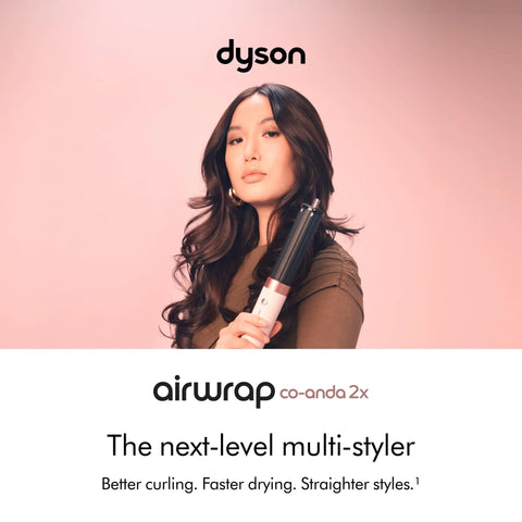Person holding Coanda 2x Airwrap Multi Styler And Dryer For Straight And Wavy Hair In Ceramic Pink, advertising faster drying.