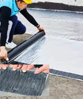 Applying Tough As Nails Waterproof Roof Repair Tape, Super Sticky Bitumen Sealing Roll on a roof to seal leaks.