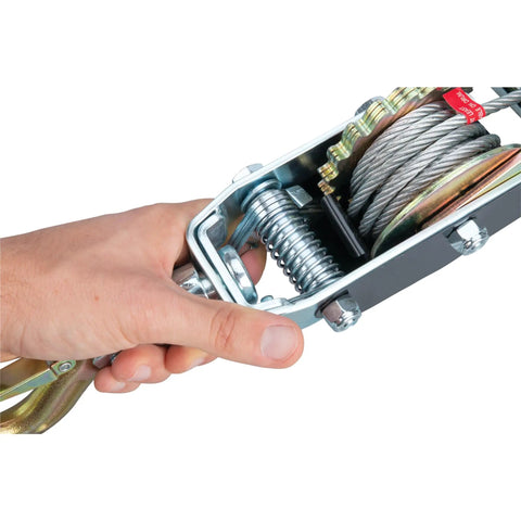 Hand holding Power Puller 4 Ton Capacity Heavy Duty Beast Cable Winch mechanism, showing metal cable and spring detail.