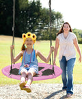 Child swinging on 40 Inch Pink Unicorn Saucer Swing for Kids With Adjustable Ropes and 2 Carabiners Waterproof 900D Oxford Cloth.