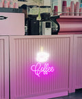 Coffee Cup LED Neon Sign For Home, Cafe, Bar, Or Office, Dimmable 3D Light Up Night Light Wall Decor against pink counter