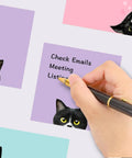 Hand writing on Nine Pad Cat Themed Sticky Notes Set In Pink With Super Adhesive Self Stick Notes, 3x3 Inch Memo Pads
