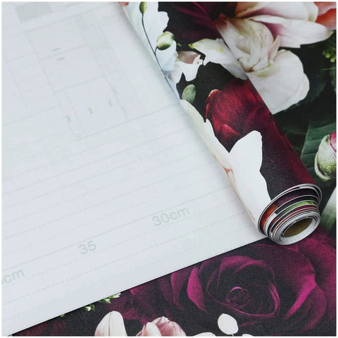 Peel And Stick Floral Wallpaper With Rose And Daisy Pattern Removable Self Adhesive Mural For Walls Easy Install Renter Friendly Durable Vinyl Eco Friendly Ink No Mess 17.7 X 9.8 Feet Black Pink Purple partially unrolled showing floral design