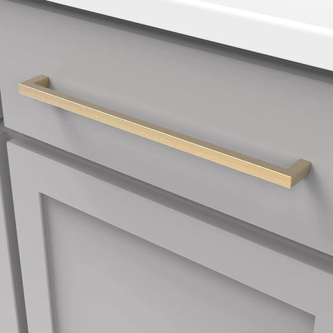 Solid Core Kitchen Cabinet Pulls In Brushed Golden Brass, 12 Inch Hole Center mounted on a gray cabinet, Skylight Collection