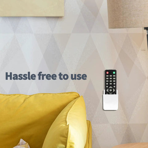 Two Pack Wall Mounted Remote Control Holder Set With Self Adhesive Backing And Screws, White Finish, on wall with remote