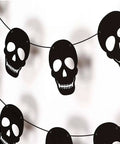 Bold Black Skull Garland Decorations For Halloween And Gothic Parties Edgy Horror Banner Decor Perfect For Haunted Houses Pirate Themed Nights Rock And Metal Venues Dark Aesthetic Events featuring 36 black skulls on cardstock.
