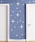 82 Piece 3D Acrylic Mirror Star Wall Stickers Set For Ceiling And Walls on blue wall between white doors