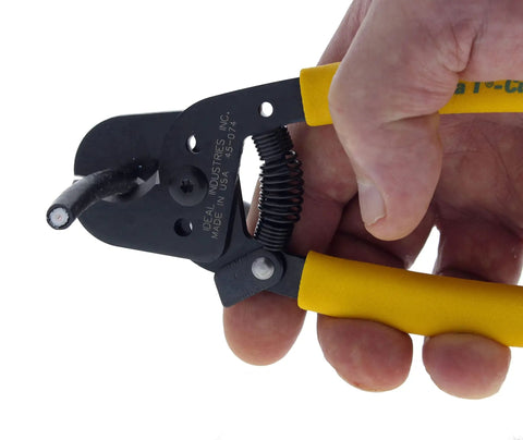 Hella Versatile Data T Cutter Wire Tool For Structured Networks And Coax Cables Up To Rg 11 held in hand, cutting coax cable.