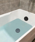 No Fuss Matte Black Tub Drain Kit With Overflow Tube Fitting Every Bathtub in a filled bathtub showing drain and overflow.
