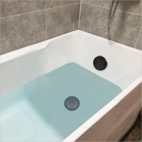No Fuss Matte Black Tub Drain Kit With Overflow Tube Fitting Every Bathtub in a filled bathtub showing drain and overflow.