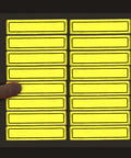 Hand holding sheet of Yellow Retro Reflective Hard Hat Stickers 1 By 4 Inch Pack Of 16 Durable Helmet Decals for safety