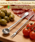 Six-Piece Pickle Fork Set with stainless steel long-handle fork and spoon beside olives and tomatoes on wooden board.