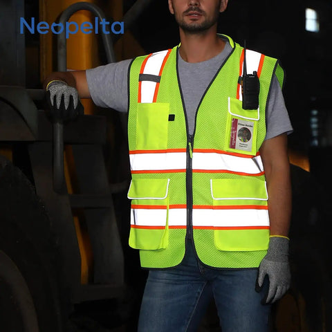 High Visibility Work Safety Vest ANSI Class 2 yellow mesh with pockets and zipper, padded neck and reflective trim, worn by a worker