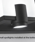 Close-up of Slick Black LED Vanity Light 4 Light Modern Bath Fixtures showing bottom-mounted spotlight on matte black back plate.