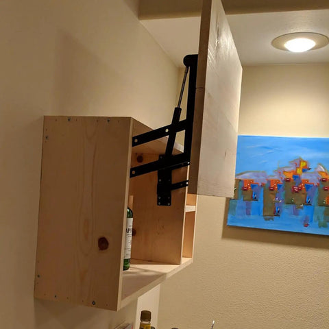 Solid Built One Pair 10 Inch Gas Lift Hinges For Coffee Tables Hella Smooth Motion Handles 100 Pounds mounted on wooden cabinet.