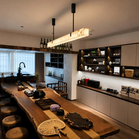 Artpad 47.24-Inch Modern Long Marble Dining Pendant Light, Suspension Lamp above a wooden dining table in a stylish kitchen.