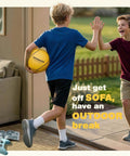 Boy holding tetherball with another boy outdoors; Ultimate Tetherball Set With Ball, Rope And Carabiner For Backyard Fun labeled on ball.