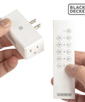 Person holding a plug and remote from a Wireless Remote Outlet Pack With Five Outlets And Two Remotes For Easy Home Control Plug And Play Smart Switches For Lamps Fans And Small Appliances Simple Convenient Hands Free Power
