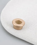 8 Pack Flanged Copper Sleeve Bushings 8 Mm Bore 12 Mm OD 8 Mm Long displayed on a textured surface, showcasing flanged design.