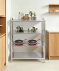 Knockout Four Tier Stainless Steel Shelving Rack With Adjustable Heights And Rock Solid 330 Pounds Heavy Duty Frame Built Tough For Garage Basement Or Kitchen Space Saving Storage Silver in kitchen setting with cookware.