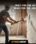 Person using Five Piece Fiberglass Handle Hammer And Mallet Set for demolition, showing 3lb sledge with ergonomic Duragrip handle.