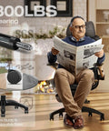 Man sitting on X100 Ergonomic Mesh Office Chair With Footrest For All Day Comfort In Home Office And Gaming Game Ready, reading newspaper