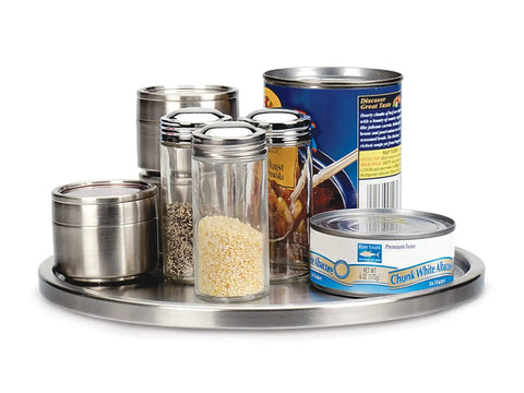 Slick Brushed Stainless Steel Lazy Susan Turntable displaying spice jars and tins, 10.5 inches wide for pantry organization.